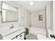Modern bathroom with white vanity, decorative tiles, and a shower-over-tub combo at 4910 W Caven St, Indianapolis, IN 46241