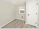 A bright bedroom with laminate flooring, neutral-painted walls, and a closet door at 4910 W Caven St, Indianapolis, IN 46241