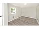 A bright bedroom with laminate flooring and neutral-painted walls at 4910 W Caven St, Indianapolis, IN 46241