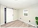 Bright bedroom featuring a barn door, stylish laminate floors and plenty of light at 4910 W Caven St, Indianapolis, IN 46241