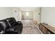 Cozy living room with hardwood floors and a comfortable leather sofa at 4910 W Caven St, Indianapolis, IN 46241