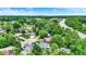 Aerial view of a home nestled in a lush, green neighborhood, showcasing its proximity to local roads and city views at 50 Charing Cross Rd, Indianapolis, IN 46217