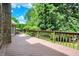 Wide wooden deck featuring railings and access to a serene and verdant backyard setting at 50 Charing Cross Rd, Indianapolis, IN 46217
