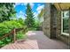 Expansive wooden deck with railing, surrounded by lush greenery for privacy and shade at 50 Charing Cross Rd, Indianapolis, IN 46217