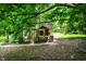 Backyard features a chicken coop near green foliage at 50 Charing Cross Rd, Indianapolis, IN 46217
