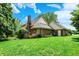 A wide shot of the home from the backyard, surrounded by lush green landscaping at 50 Charing Cross Rd, Indianapolis, IN 46217
