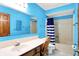 Bathroom with blue walls and a vanity, mirror, toilet and tub at 50 Charing Cross Rd, Indianapolis, IN 46217