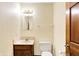 Bathroom featuring a single sink vanity, toilet and mirror at 50 Charing Cross Rd, Indianapolis, IN 46217