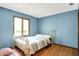 Cozy bedroom featuring hardwood floors, light blue walls, and a wrought iron bed frame at 50 Charing Cross Rd, Indianapolis, IN 46217