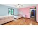 Bright bedroom featuring hardwood floors and a window view of the backyard at 50 Charing Cross Rd, Indianapolis, IN 46217