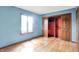 Light-filled bedroom showcasing wood floors and sliding-door closet for ample storage at 50 Charing Cross Rd, Indianapolis, IN 46217