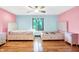 Large bedroom featuring hardwood floors, two beds, two nightstands, and a window view at 50 Charing Cross Rd, Indianapolis, IN 46217