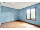 Empty bedroom showcasing wood floors and bright window with natural light and views at 50 Charing Cross Rd, Indianapolis, IN 46217