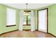 Dining area featuring a chandelier, bay window, and an exit door at 50 Charing Cross Rd, Indianapolis, IN 46217