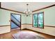 Traditional dining room with hardwood floors, decorative trim, and a window overlooking the well-landscaped yard at 50 Charing Cross Rd, Indianapolis, IN 46217