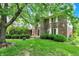 Brick home with a landscaped front yard at 50 Charing Cross Rd, Indianapolis, IN 46217