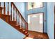 Inviting foyer with wooden stairs, hardwood floors, and a bright white front door with sidelights at 50 Charing Cross Rd, Indianapolis, IN 46217