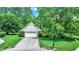 Charming home exterior featuring a two-car garage, lush landscaping, and well-maintained lawn at 50 Charing Cross Rd, Indianapolis, IN 46217