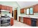 Kitchen featuring wood cabinetry, stainless steel appliances, and light green walls at 50 Charing Cross Rd, Indianapolis, IN 46217