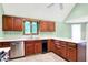 Kitchen showcasing wood cabinetry, light green walls, and stainless steel dishwasher at 50 Charing Cross Rd, Indianapolis, IN 46217