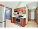 Kitchen area featuring stainless steel appliances, wood cabinetry, and light green walls at 50 Charing Cross Rd, Indianapolis, IN 46217