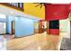 Bright living room with hardwood floors, red and yellow accent wall, and open floor plan at 50 Charing Cross Rd, Indianapolis, IN 46217