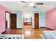Spacious main bedroom featuring hardwood floors, a ceiling fan, and a bathroom vanity at 50 Charing Cross Rd, Indianapolis, IN 46217