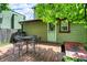 Green backyard featuring a fenced perimeter, a wooden deck with table and chairs, and access to the house at 514 Dorman St, Indianapolis, IN 46202