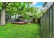 Green backyard featuring a fenced perimeter, a wooden deck, and access to the house at 514 Dorman St, Indianapolis, IN 46202