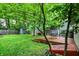 Lush backyard featuring a wooden deck, garden shed, mature trees, and a well-maintained lawn at 514 Dorman St, Indianapolis, IN 46202