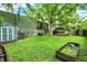 Green backyard featuring a shed, fenced perimeter, and a wooden deck at 514 Dorman St, Indianapolis, IN 46202
