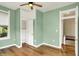 Light green bedroom boasts hardwood floors, a closet, and a classic window for an inviting appeal at 514 Dorman St, Indianapolis, IN 46202