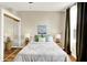 Inviting bedroom features hardwood floors, a comfortable bed, and ample natural light from a window at 514 Dorman St, Indianapolis, IN 46202