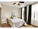 Cozy bedroom with a ceiling fan, warm hardwood floors, and natural light from large windows at 514 Dorman St, Indianapolis, IN 46202