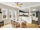 Bright dining space featuring a white table, wood floors, and natural light from large windows at 514 Dorman St, Indianapolis, IN 46202