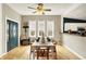 Bright dining space featuring a white table, wood floors, and natural light from large windows at 514 Dorman St, Indianapolis, IN 46202