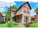 Charming two-story home with red trim, a covered front porch, and beautiful landscaping at 514 Dorman St, Indianapolis, IN 46202