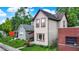 Charming two-story home with light siding, red trim, and lush landscaping in a residential neighborhood at 514 Dorman St, Indianapolis, IN 46202