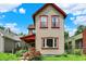 Attractive two-story home with red trim, a covered front porch, and vibrant red roses at 514 Dorman St, Indianapolis, IN 46202