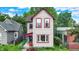Charming two-story home with light siding, red trim, and lush landscaping in a residential neighborhood at 514 Dorman St, Indianapolis, IN 46202