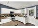 A well-lit kitchen featuring white cabinets, stainless steel appliances, and a stylish backsplash and access to the backyard at 514 Dorman St, Indianapolis, IN 46202
