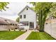 Charming two-story home with a spacious backyard patio, lush lawn, and dining area, perfect for outdoor entertaining at 5254 N Park Ave, Indianapolis, IN 46220