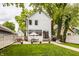 Charming two-story home with a spacious backyard patio, lush lawn, and dining area, perfect for outdoor entertaining at 5254 N Park Ave, Indianapolis, IN 46220