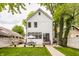 Charming two-story home with a spacious backyard patio, lush lawn, and dining area, perfect for outdoor entertaining at 5254 N Park Ave, Indianapolis, IN 46220