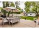 Backyard featuring outdoor dining, seating area and manicured lawn leading to garage at 5254 N Park Ave, Indianapolis, IN 46220