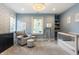 Bedroom features soothing blue walls, a cozy chair, and crib, complemented by bookshelves and natural light for a serene space at 5254 N Park Ave, Indianapolis, IN 46220
