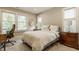 Bright bedroom with multiple windows, a comfortable bed, and classic wooden furniture creating a serene retreat at 5254 N Park Ave, Indianapolis, IN 46220
