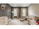 Cozy bedroom featuring two large windows, a comfortable chair, and neutral decor, creating a peaceful and inviting space at 5254 N Park Ave, Indianapolis, IN 46220