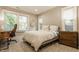Bright bedroom featuring a comfortable bed, desk area, and natural light from the multiple windows at 5254 N Park Ave, Indianapolis, IN 46220