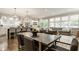 Open-concept dining and kitchen area filled with natural light, stylish lighting, and modern appliances at 5254 N Park Ave, Indianapolis, IN 46220